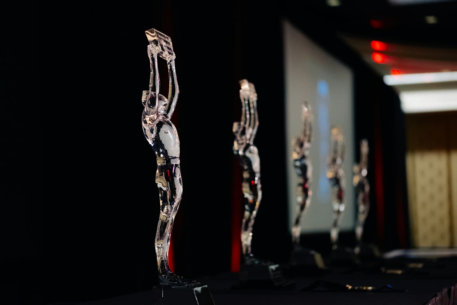 Glass award trophies lined up on stage ahead of an awards ceremony